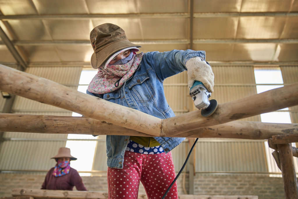 Treated bamboo poles stacked and drying in Vietnam
