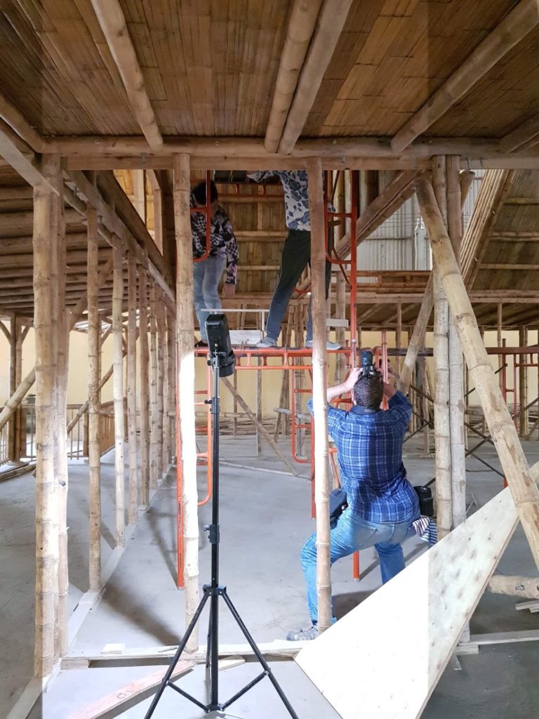 Setting up lights inside the bamboo production facility