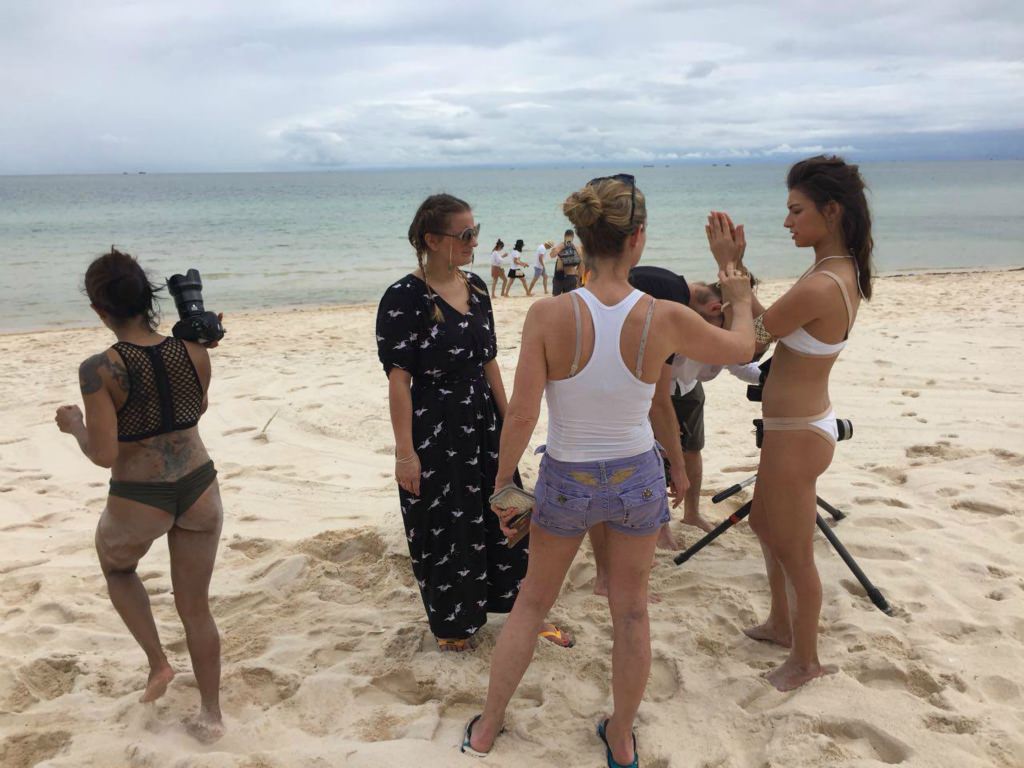 Vietnam-Video-Production-beach-commercial Creative director, and photographer, talking with the models during a commercial shoot on the beach of Vietnam