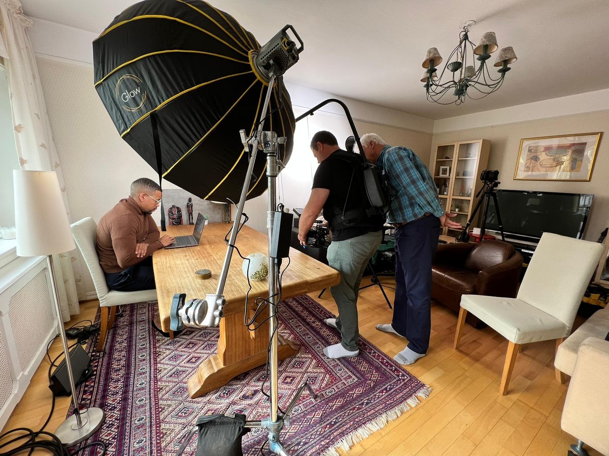 Film crew shooting corporate recruitment video at sunset on rooftop terrace in Oslo Norway